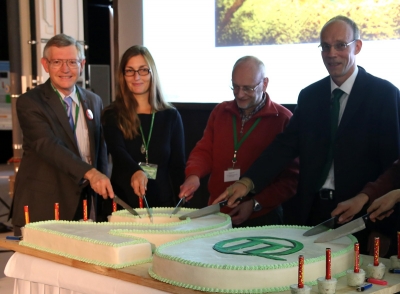 W.E. Moerner (left) cutting the anniversary cake.