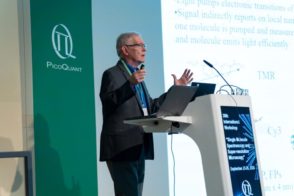 W.E. Moerner on stage giving a talk.